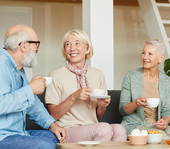 Seniors enjoying coffee and conversation together