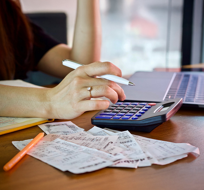 woman holding bill using calculator and calculate cost bill and payment